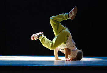 Ungdom i en dansposition med huvudet mot golvet.